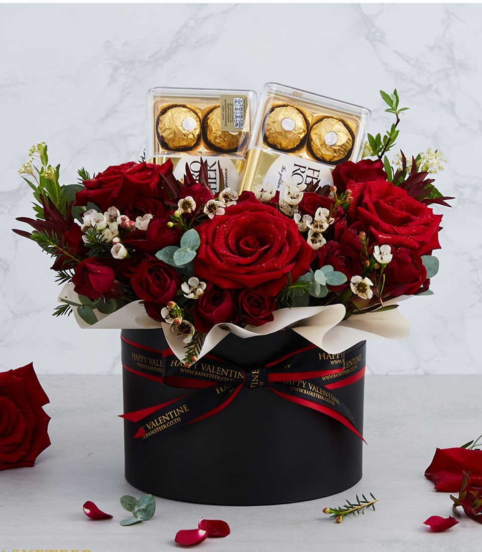 A luxurious gift box featuring Ferrero Rocher chocolates and delicate roses, symbolizing love and indulgence, perfect for expressing affection and admiration.