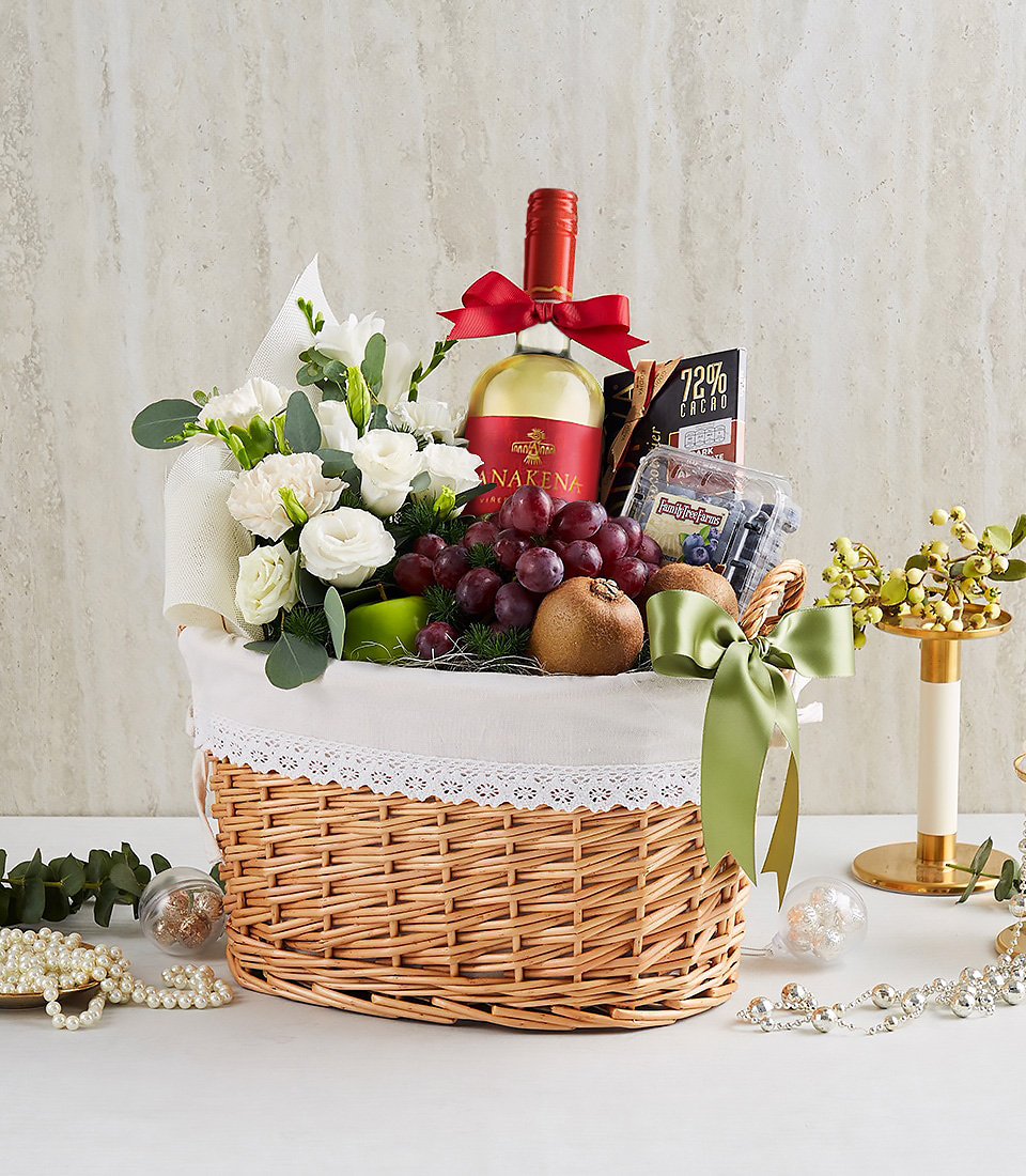Premium gift basket with wine, white roses, fresh fruits, chocolate, and greenery