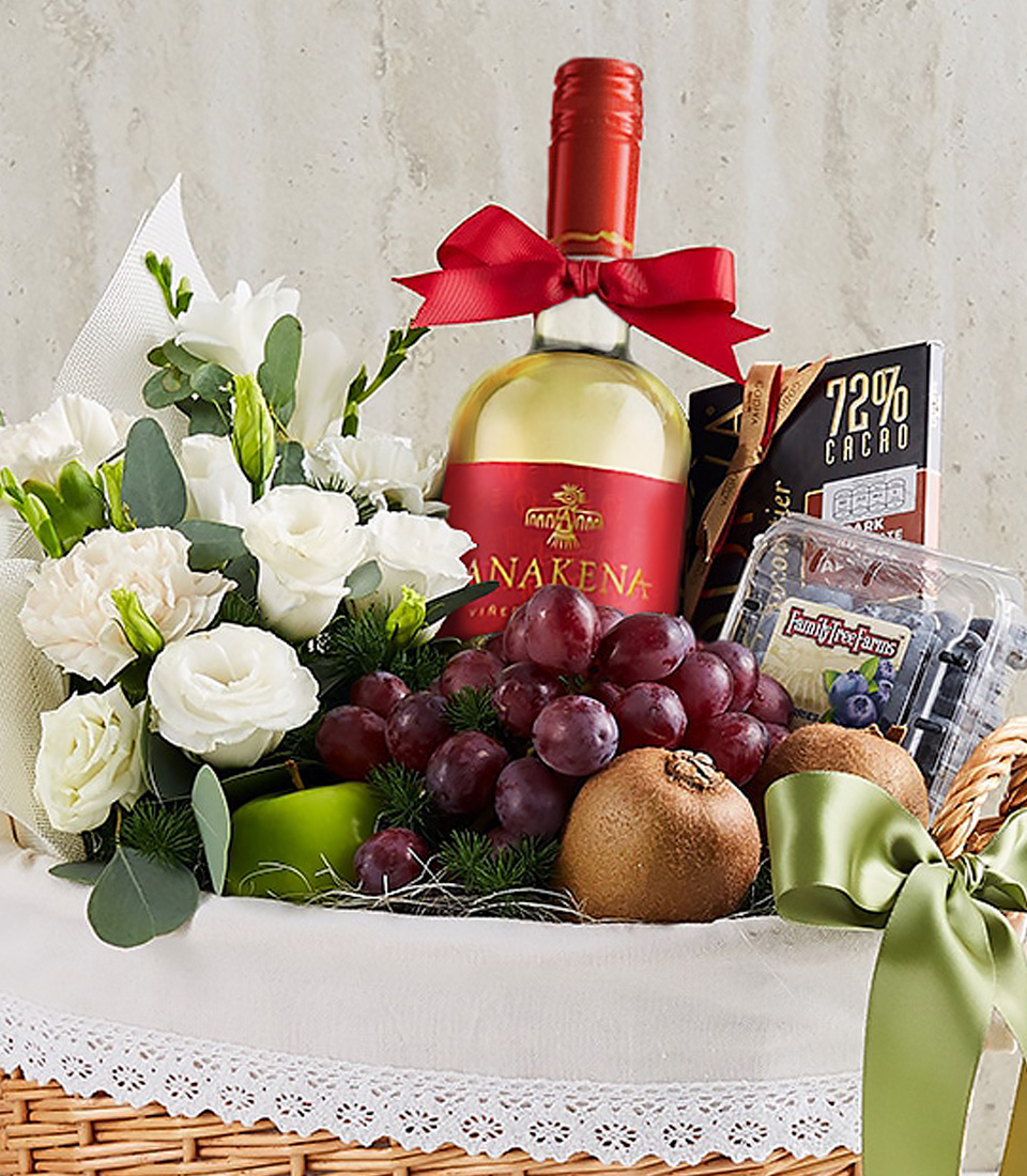 Elegant gift basket with white wine, white roses, fresh fruits, and premium chocolate