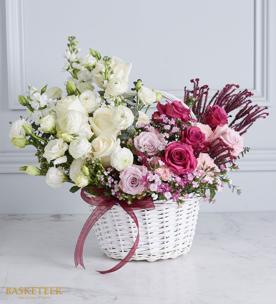 Pink And White Flowers In The White Basket With Red a Bow