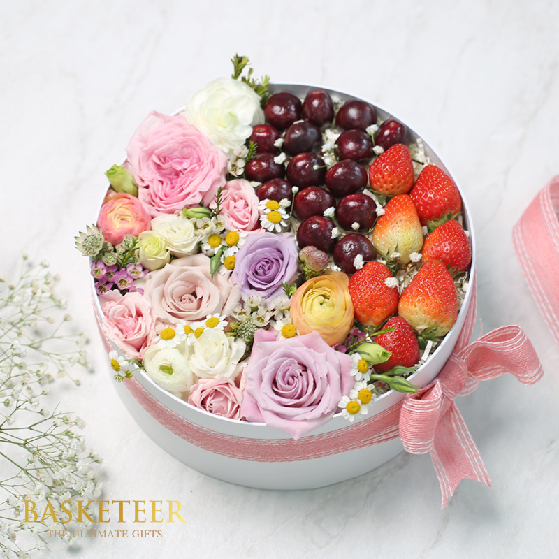 Mixed Cherries And Strawberries With Pink Flowers In The Box With Pink a Bow