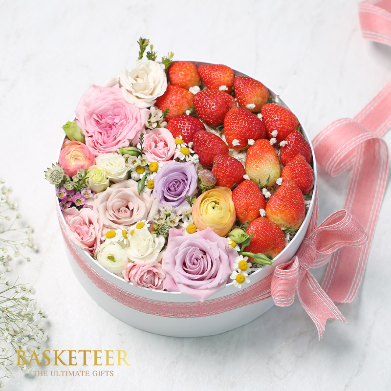 Strawberries With Sweet Pink Flowers In The White Box With a Bow