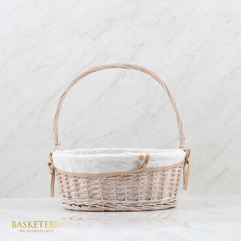 White wicker basket with long handles, lined with white fabric and light brown trim, Empty Basket