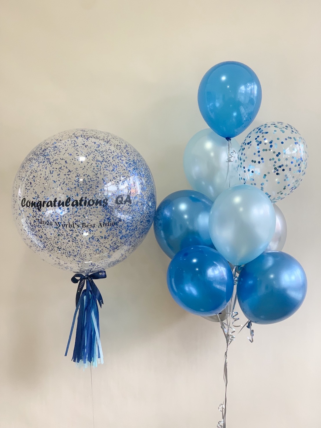 A blue-themed balloon set with metallic and confetti balloons, featuring a large congratulatory balloon with blue tassels.