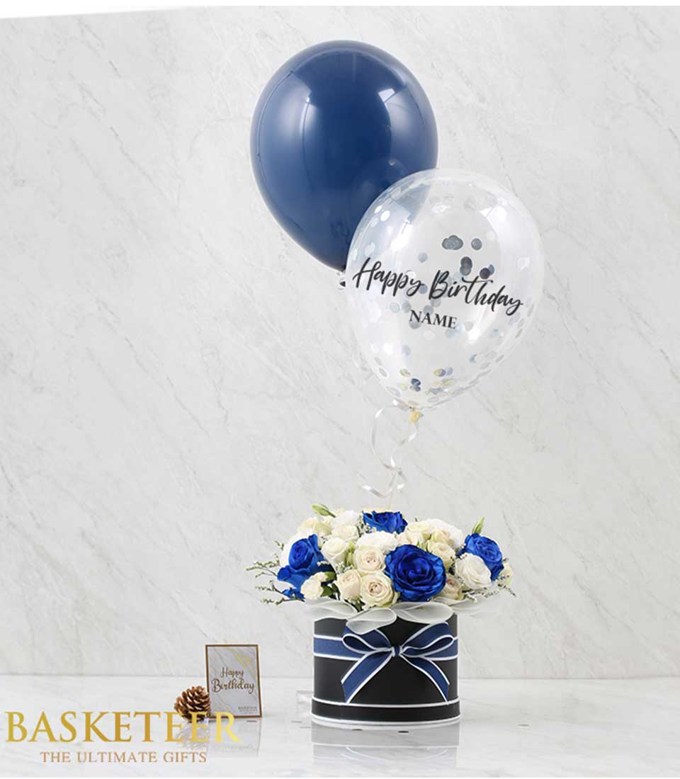 Explore our Blue White Roses Balloons Gift, featuring a stunning arrangement of white roses accented with blue blooms, complemented by festive balloons for a joyous celebration.