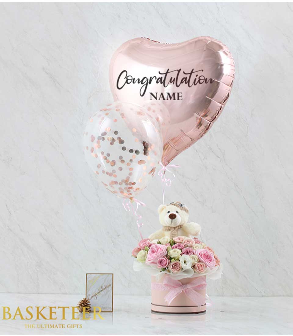 Experience sweetness and love with our adorable gift box featuring heart-shaped balloons, delicate pink flowers, and a cuddly teddy bear. Perfect for expressing affection and care.