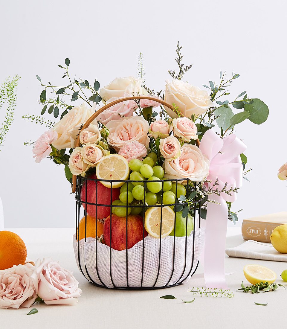Mixed Fresh Fruits With Soft Pink Flowers In The Steel Frame Basket