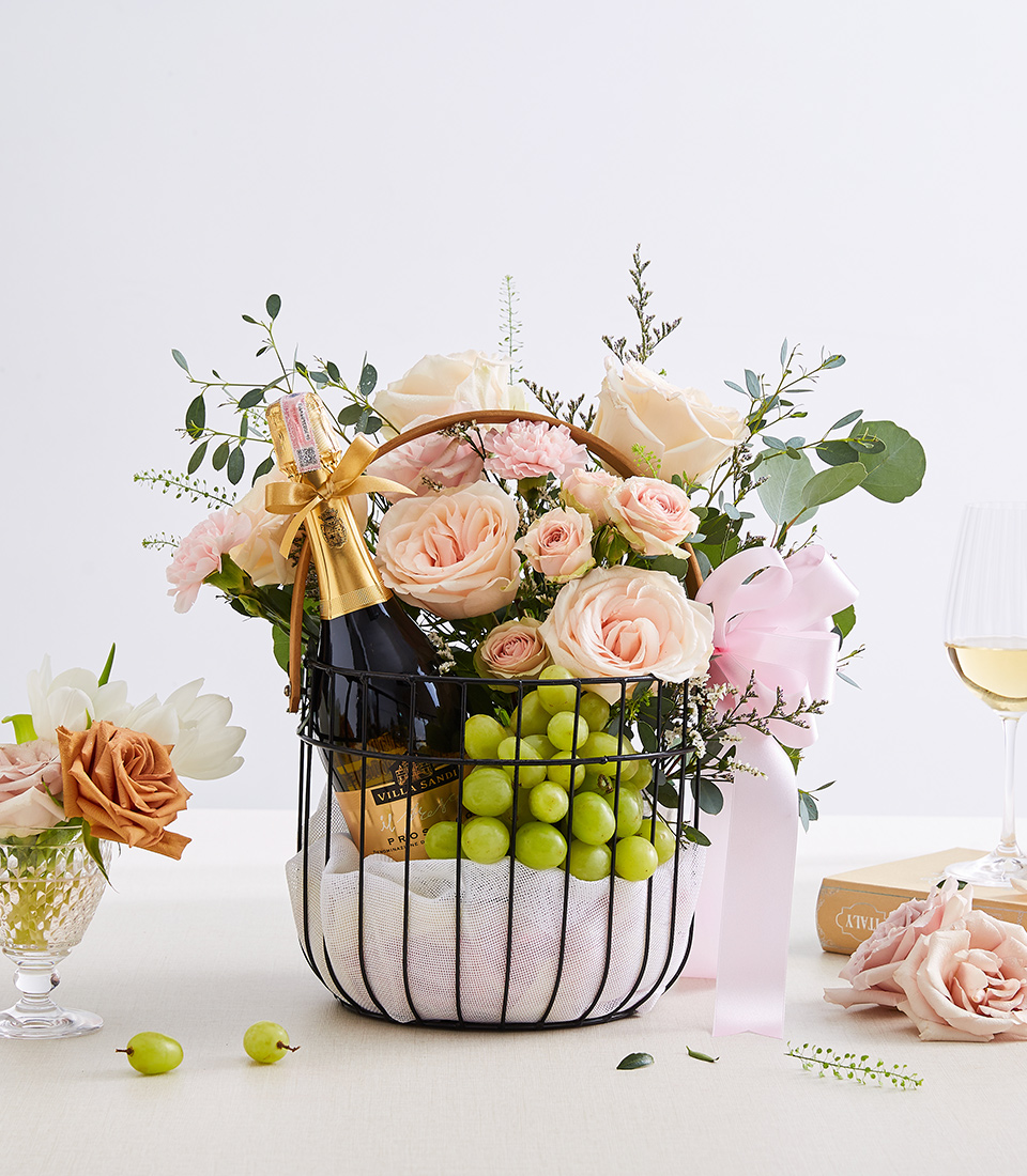Wine With Green Grape And Sweet Pink Flowers In The Black Steel Frame Basket