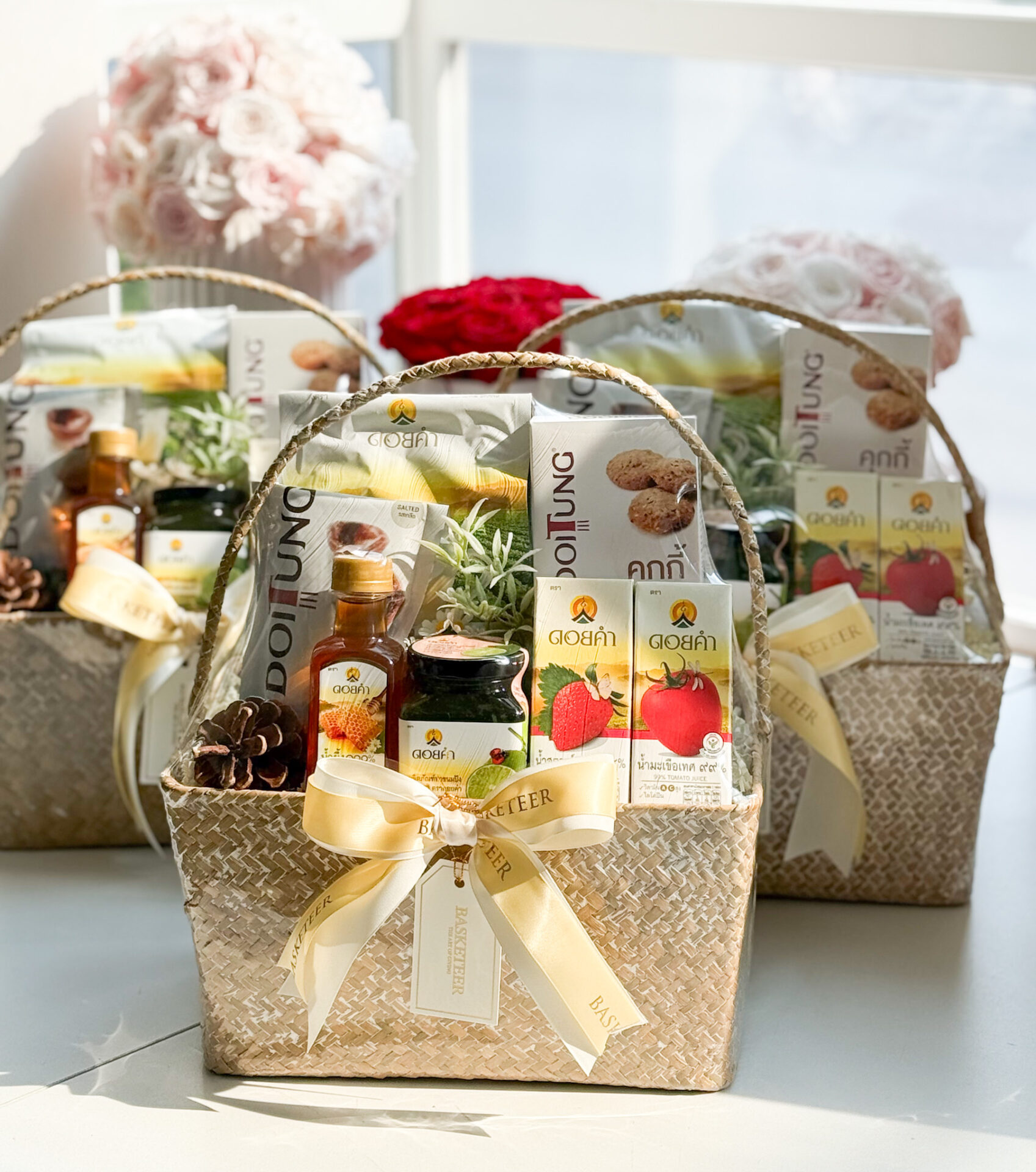 A beautifully arranged gourmet gift basket featuring premium DoiTung products in a handcrafted woven basket, adorned with a golden ribbon.