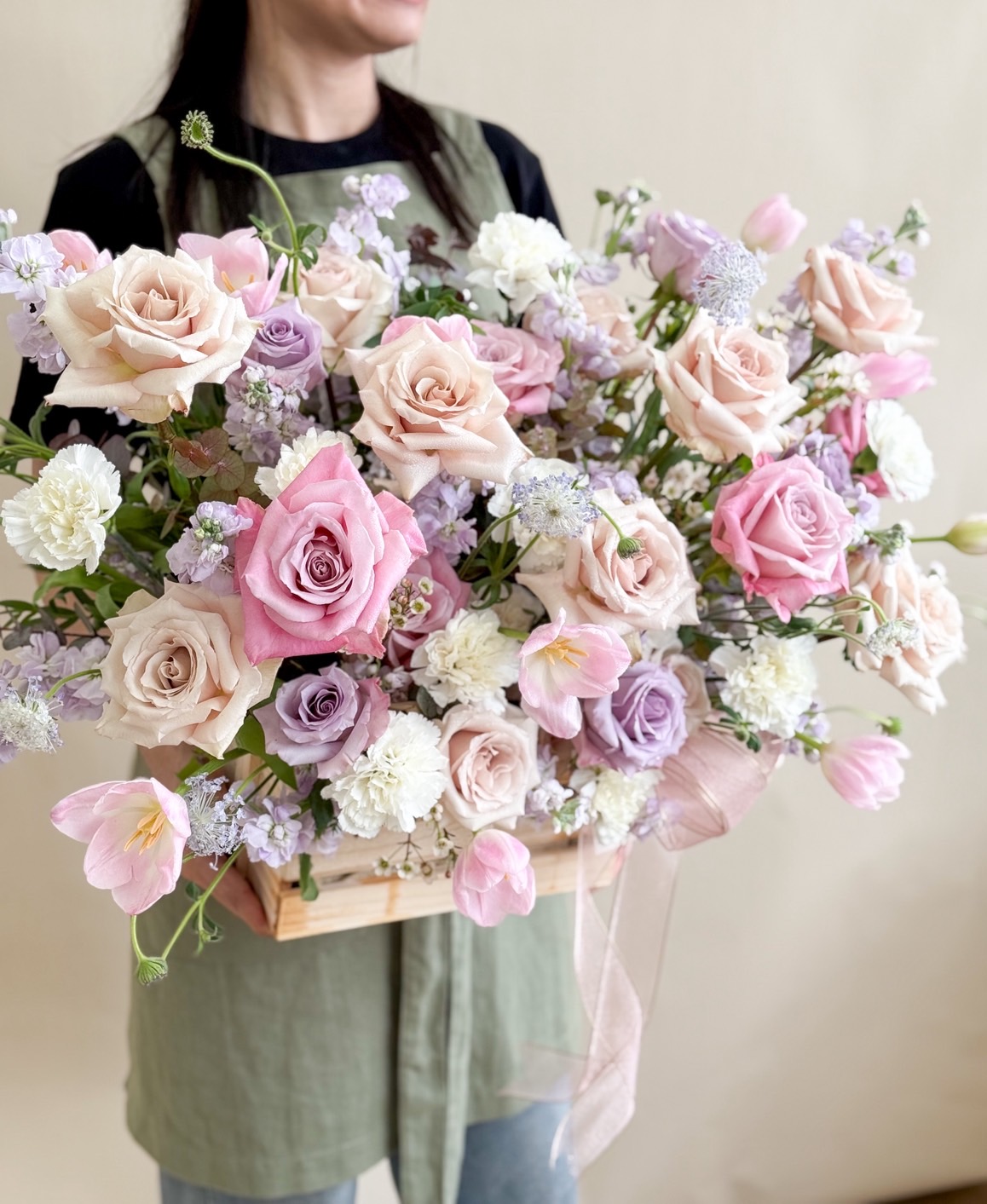 Luxurious box arrangement of pink, nude, and lilac roses with tulips and white blooms, ideal for romantic or congratulatory gifts.