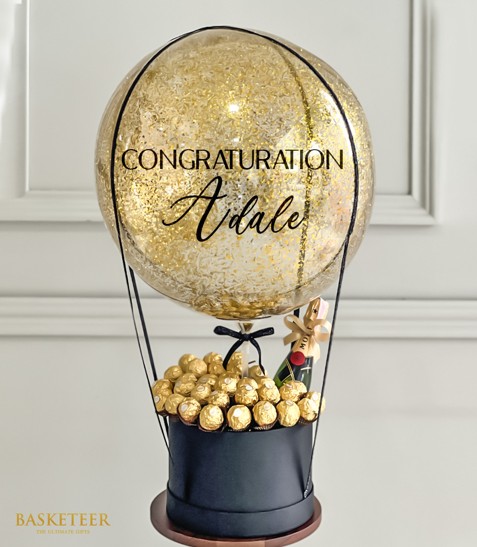 Elevate your gifting game with our luxurious Golden Balloon Ferrero Moet Wine Gift Box Set, featuring premium champagne, decadent chocolates, and festive balloons.