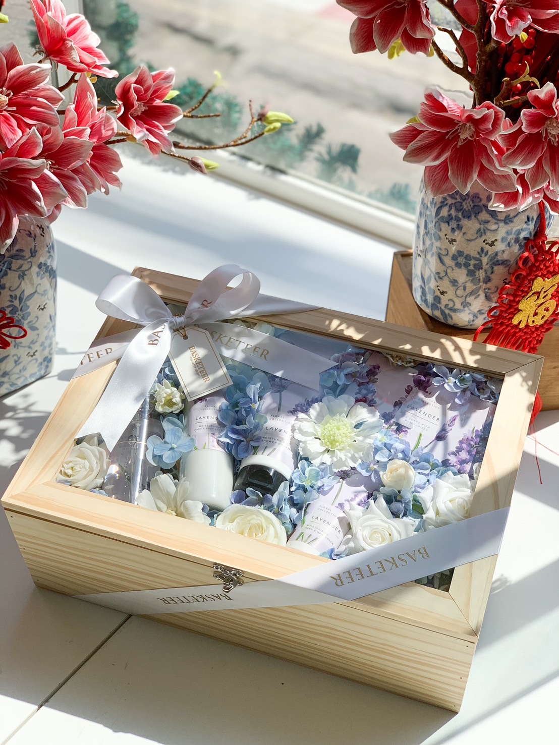 A luxury spa gift box featuring lavender-infused body care products, beautifully arranged with elegant floral details in a wooden box.