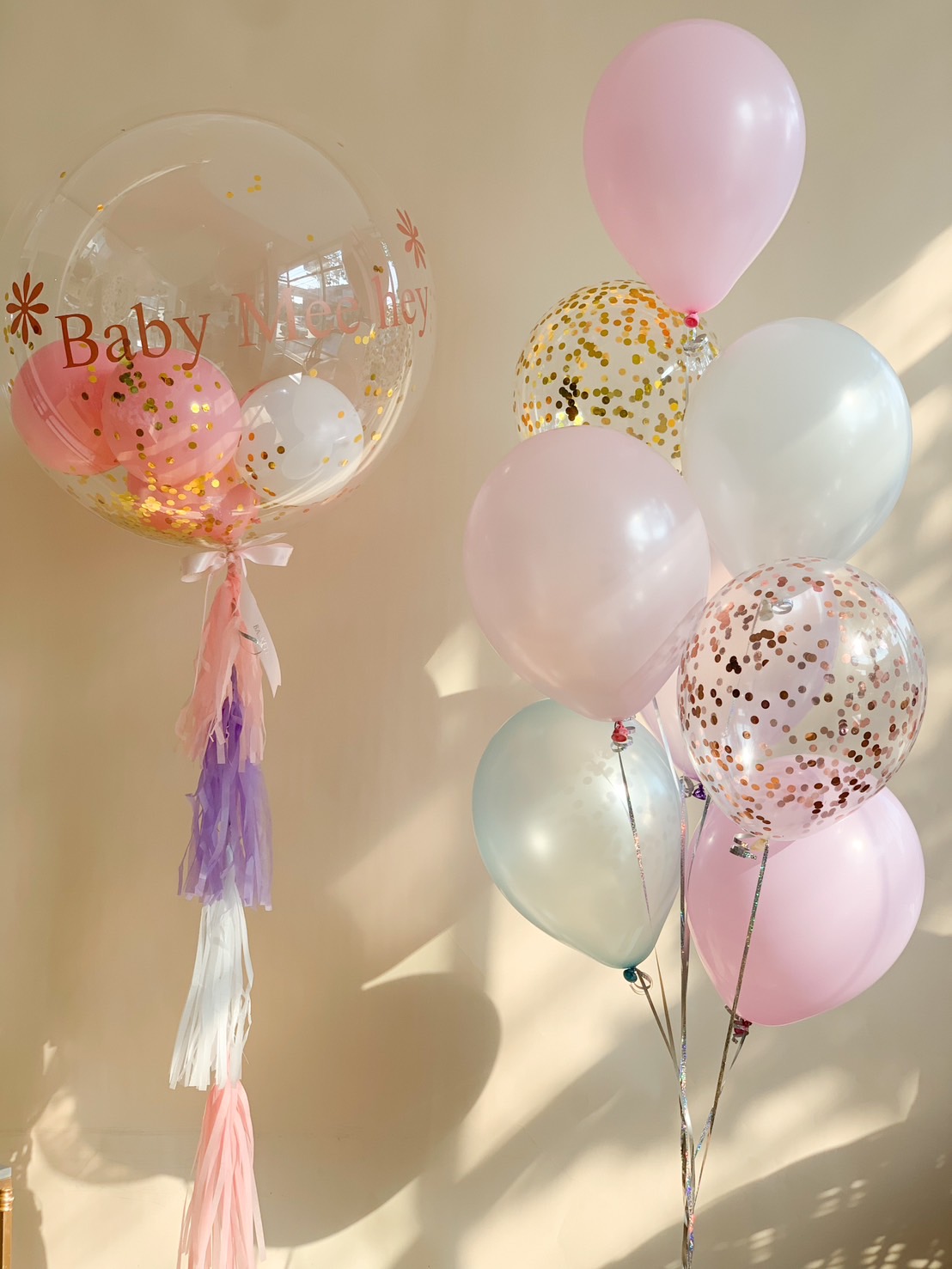 A luxury baby shower balloon set, featuring a personalized jumbo balloon with tassels, pastel latex balloons, and elegant gold confetti balloons—perfect for celebrating a newborn or gender reveal.
