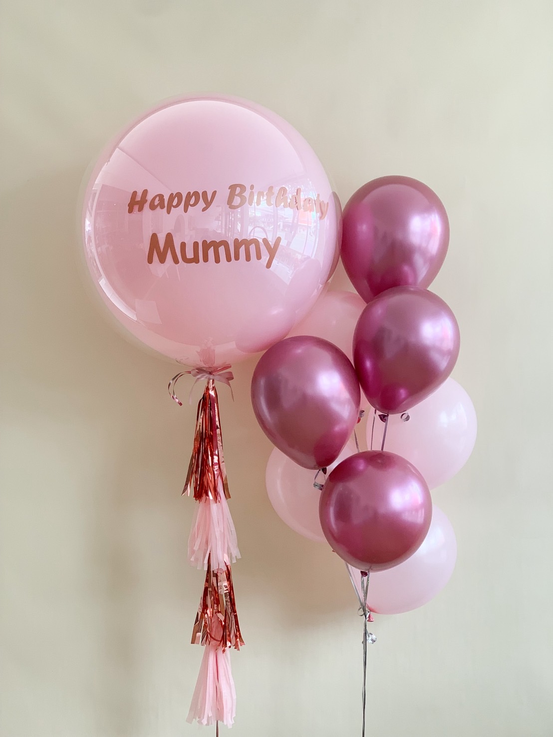 A pink and rose gold birthday balloon set with 