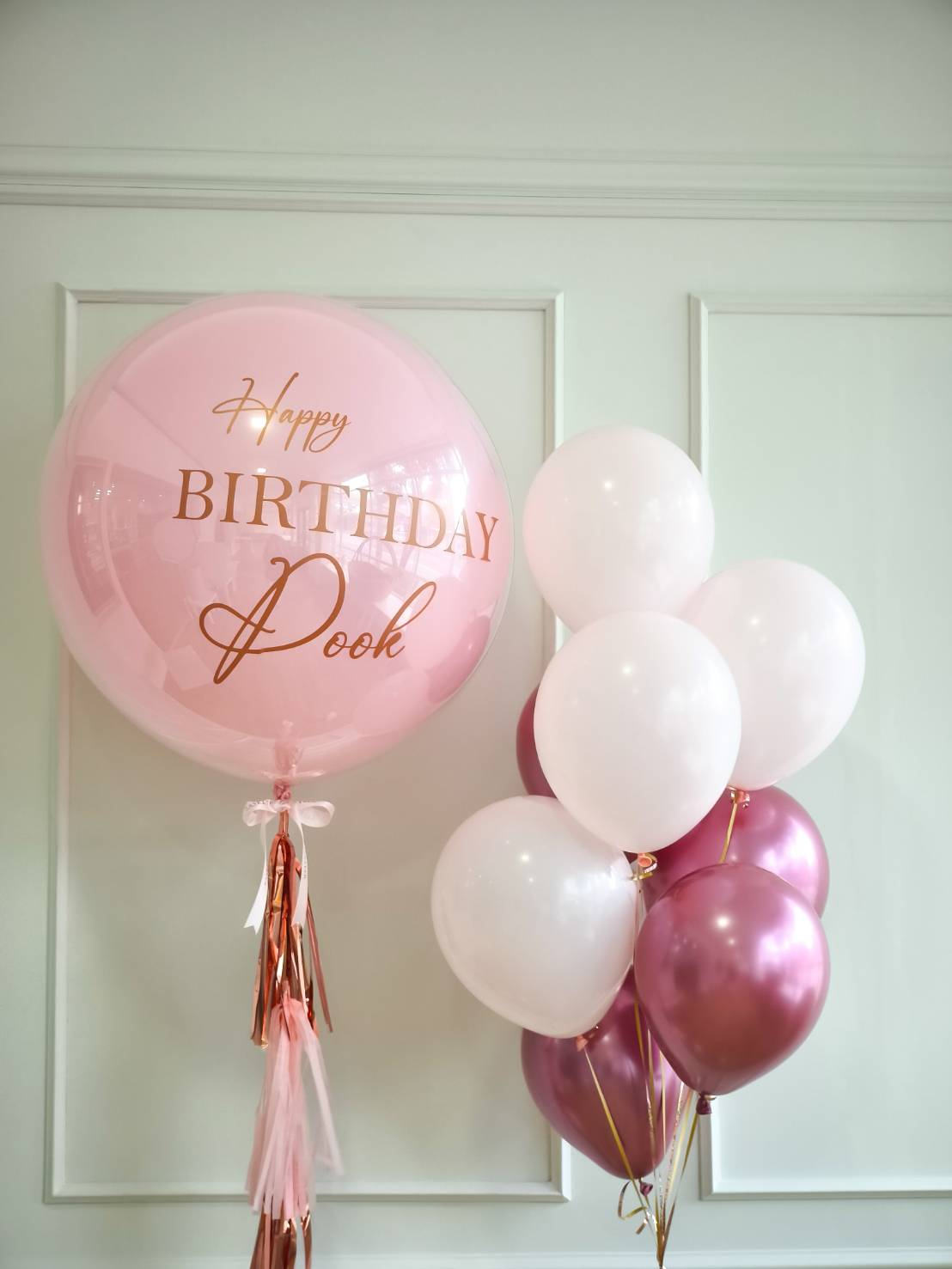 Pink and white birthday balloon set with rose gold accents and large personalised balloon saying Happy Birthday Pook