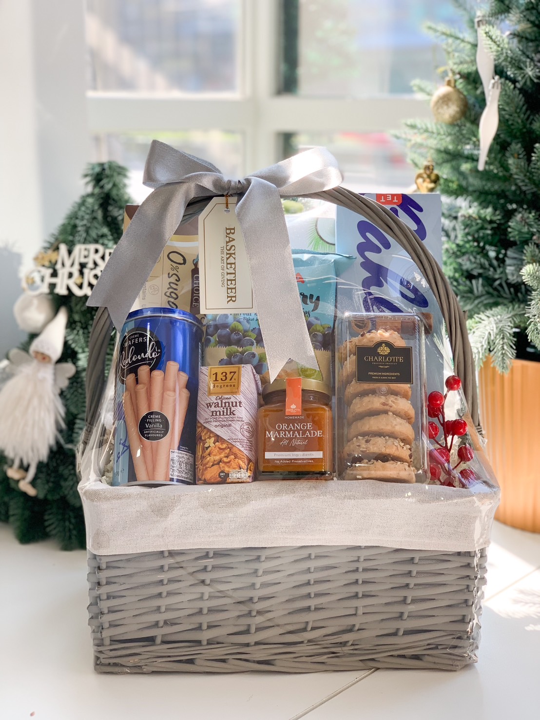 Premium gift basket featuring cookies, wafer rolls, orange marmalade, walnut milk, and gourmet snacks by Basketeer.