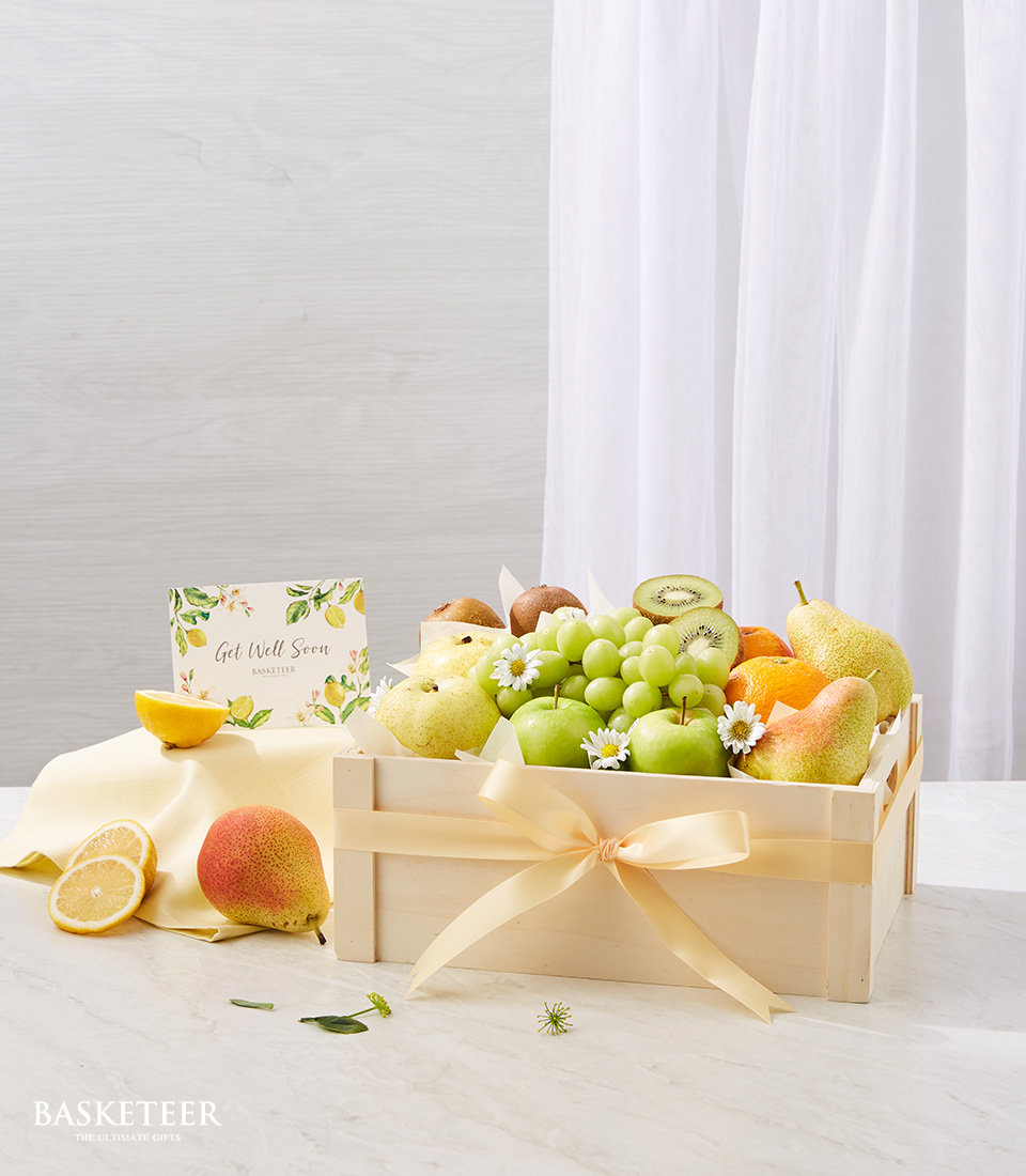 Fresh Fruits In Wooden Box With A Small Sunflower Vase