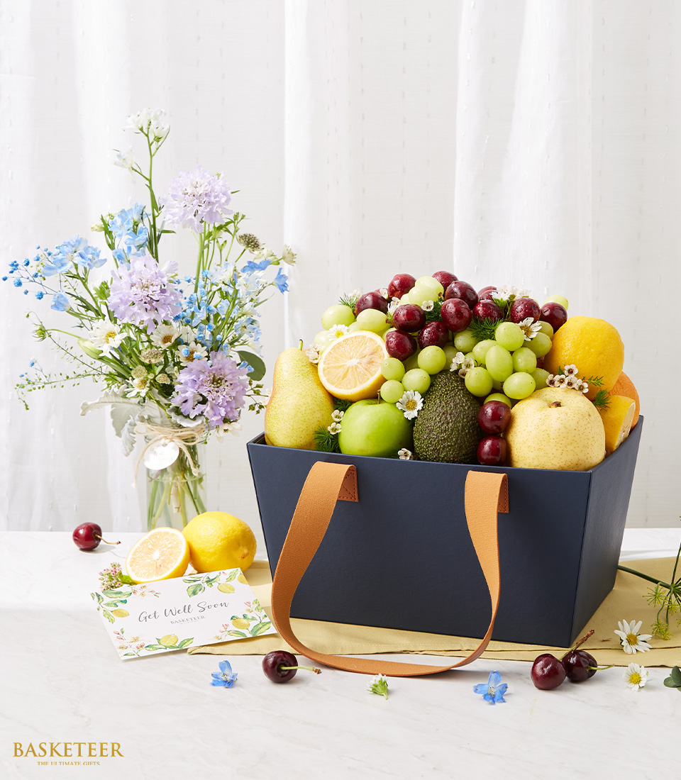 Fresh Fruits Gift In The Navy Blue Bag Box With A Small Bright Flowers In Vase