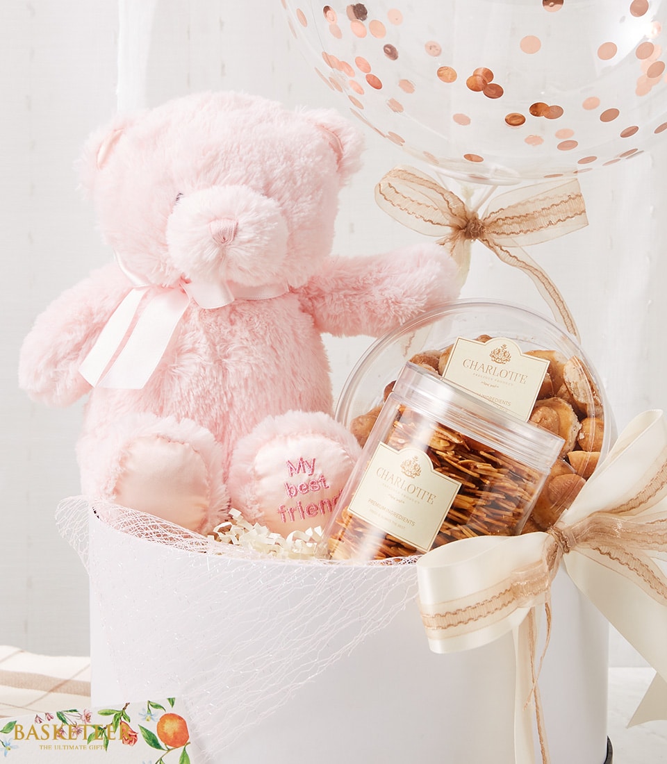 A luxurious gift set from Basketeer, featuring a soft light pink teddy bear with elegant 