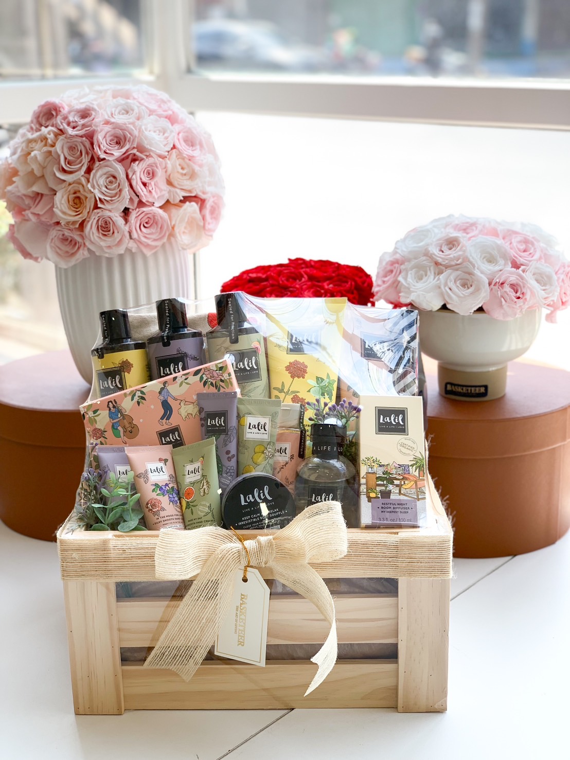A luxurious spa and self-care gift basket featuring La Lill bath & body products, beautifully arranged in a wooden crate with a natural ribbon. Includes body wash, lotion, hand cream, and scented products, making it a perfect relaxation gift.