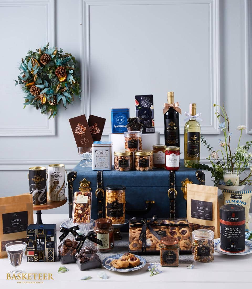 An exclusive arrangement of two premium wine bottles elegantly presented in a luxurious navy blue leather-bound box. Accompanied by rich chocolates and delectable treats, this sophisticated collection is a feast for the senses.