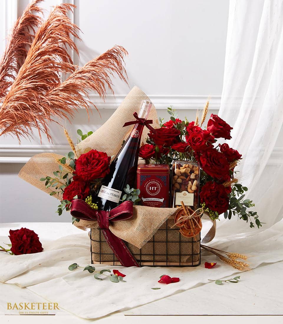 Indulge in luxury with our Red Rose Wine Bliss Basket, featuring a selection of fine wine, mixed nuts, and premium tea. Elevate your gifting experience with this exquisite combination of flavors and aromas.