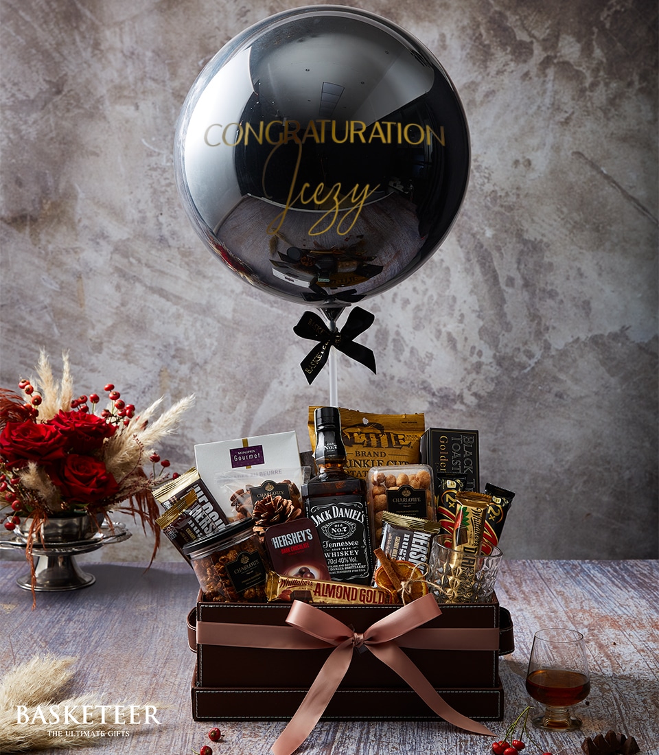 A luxurious and inviting gift arrangement showcasing a grand silver balloon adorned with 