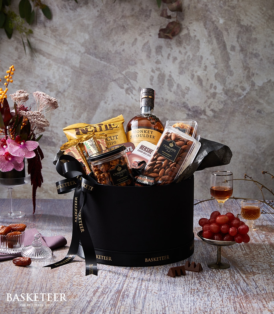 A luxurious black gift basket adorned with the elegant 