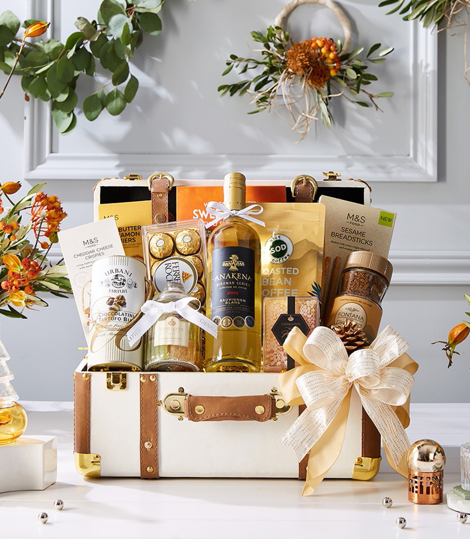 Luxury hamper with Anakena Sauvignon Blanc wine, Ferrero Rocher, Urbani truffle chocolate, M&S cheese crisps, breadsticks, coffee, and premium treats.