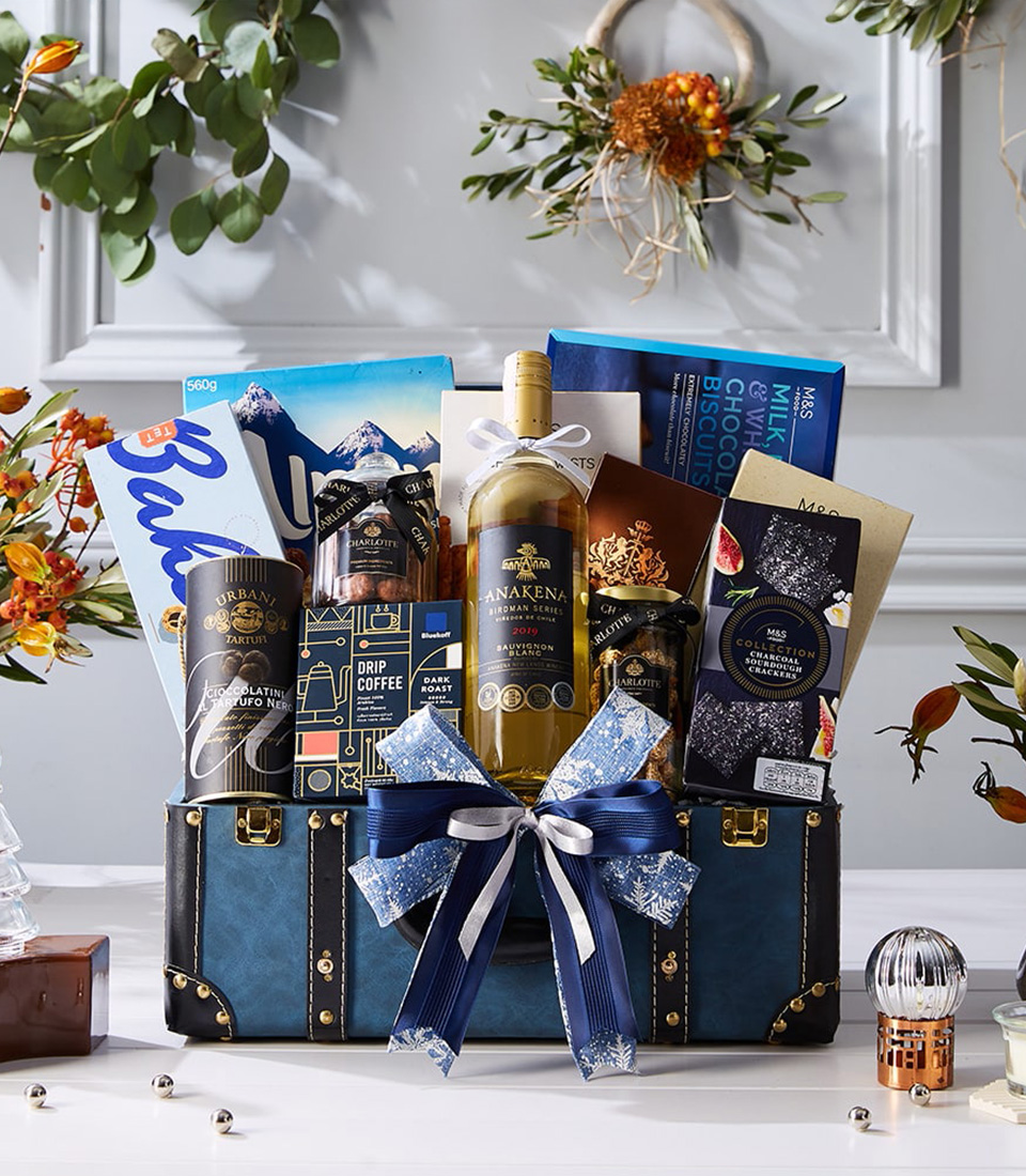 Luxury blue chest hamper with white wine, premium biscuits, drip coffee, chocolates, truffle snacks and festive ribbon