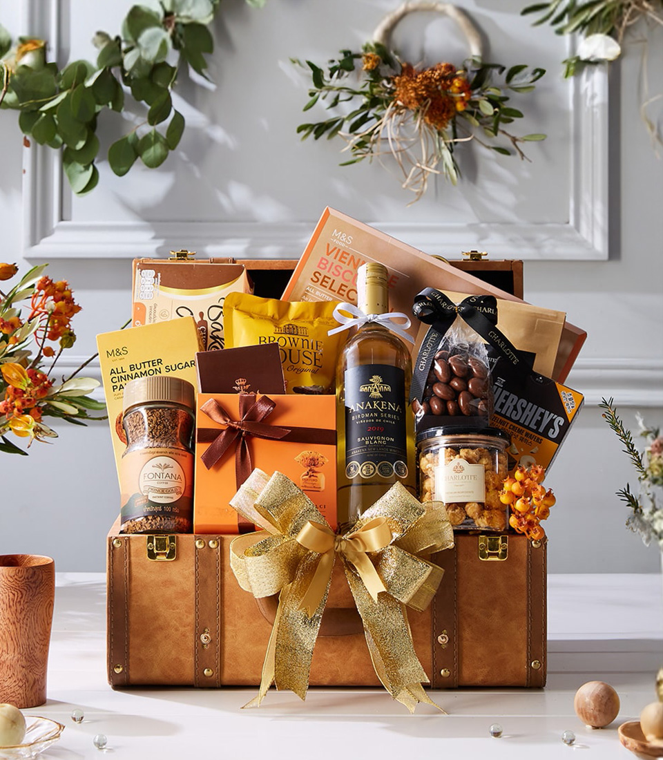 Luxury light brown chest hamper with Sauvignon Blanc white wine, biscuits, chocolates, popcorn, coffee, and gold festive ribbon