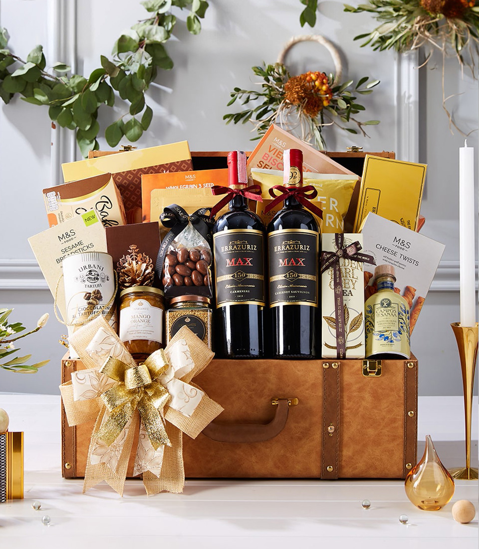 Luxury brown chest hamper with two red wines, premium chocolates, biscuits, honey, tea, nuts, and gold ribbon