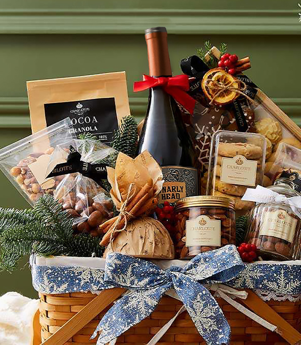Christmas hamper with Gnarly Head red wine, granola, cookies, chocolate nuts, and festive snacks in a snowflake ribbon basket