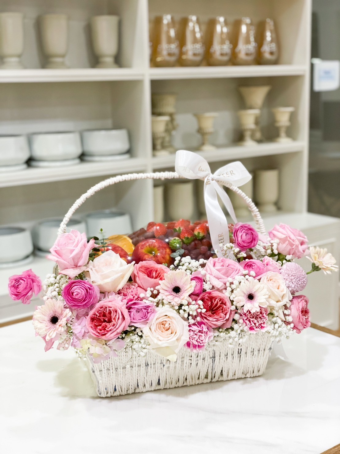 Sweet Pink Flowers With Fresh Fruits In The White Basket