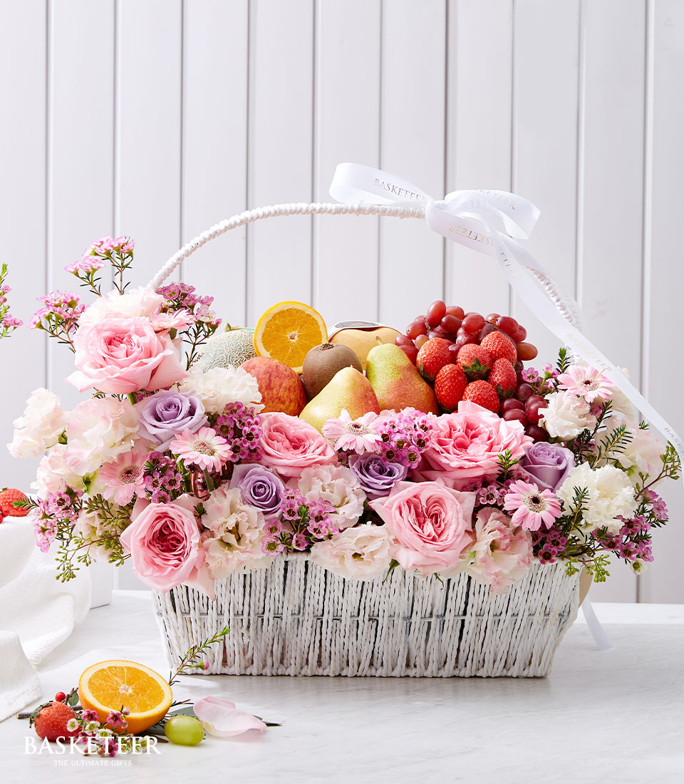 Sweet Pink Flowers With Fresh Fruits In The White Basket
