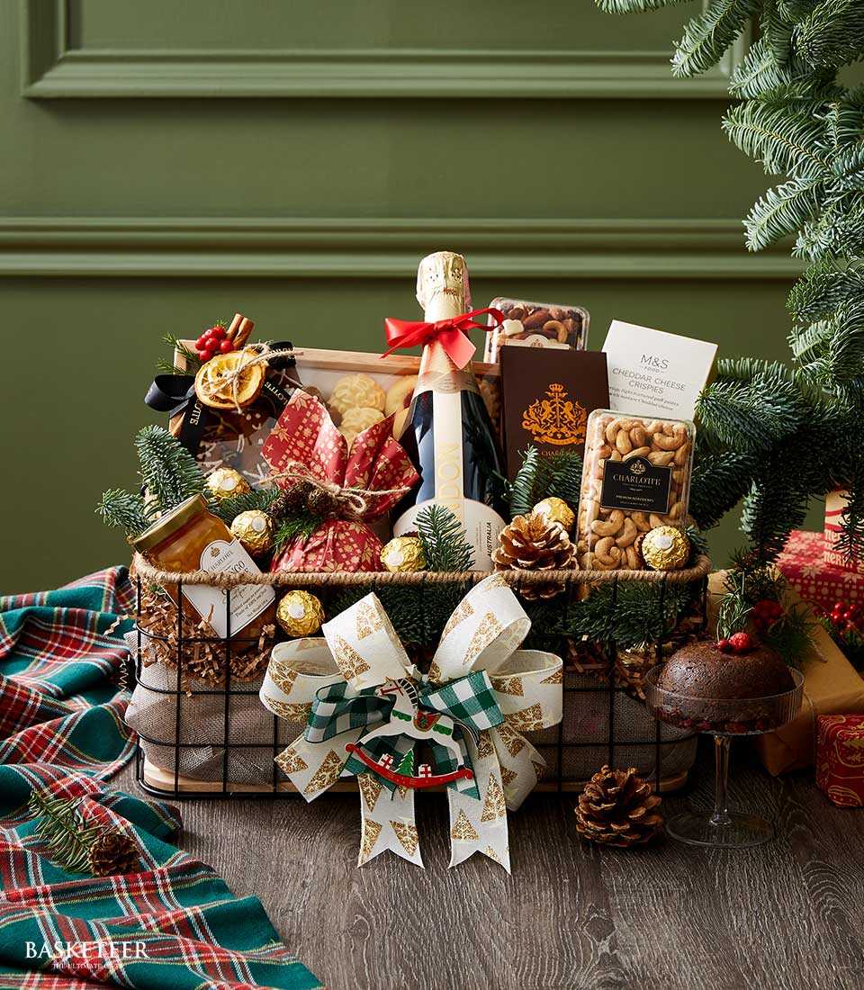 Rustic metal basket with Chandon Brut sparkling wine, cookies, nuts, chocolates, jam, and white-green Christmas bow