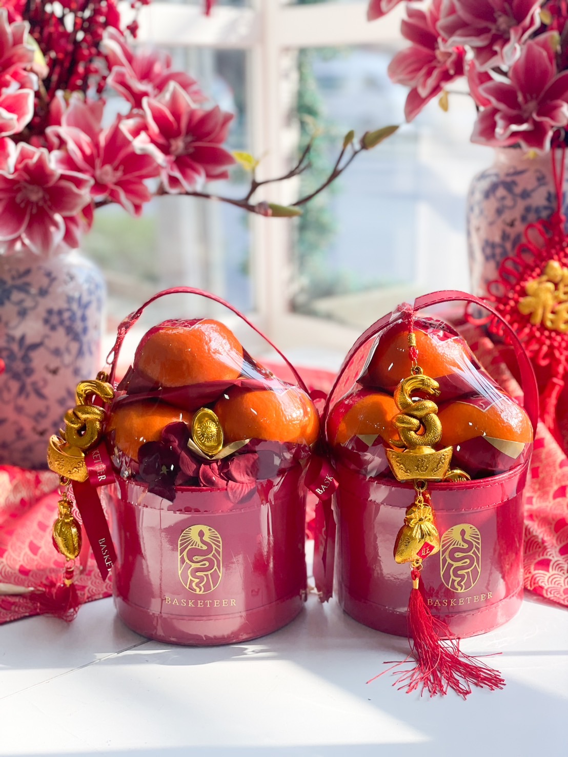 Mini Chinese New Year prosperity gift set with Mandarin oranges, red packaging, and gold prosperity charms for a festive celebration.