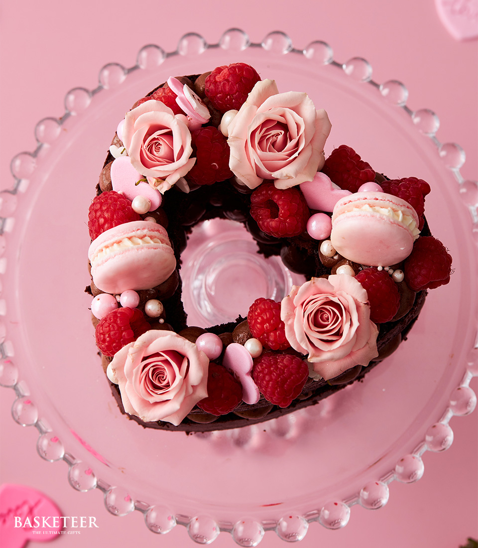 Valentine's Day Chocolate Heart Cake with Macarons, Raspberries and Fresh Pink Roses Topping.