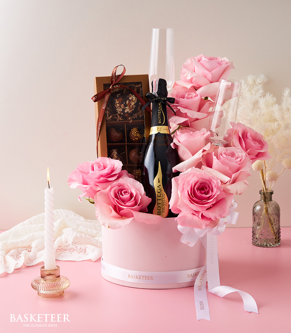 Valentine's day In Wine With Chocolate-Covered Cherries, Sweet Pink Roses and Flute Champagne Glasses In The Pink Box with a White Bow.