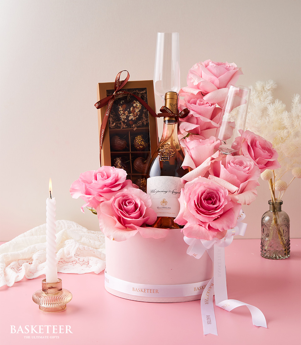 Valentine's day Wine, Pink Roses With Chocolate-Covered Cherries and Flute Champagne Glass In The Pink Box With a White Bow.