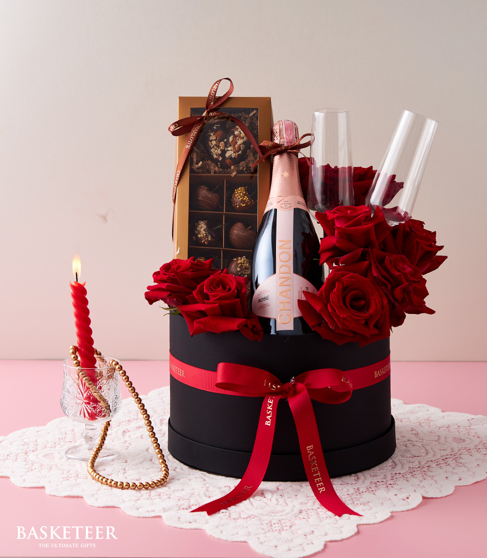 Indulge in luxury with our Red Explorer Roses Wine Set, featuring a pair of twin glasses, decadent chocolates, all presented in a sleek black box.