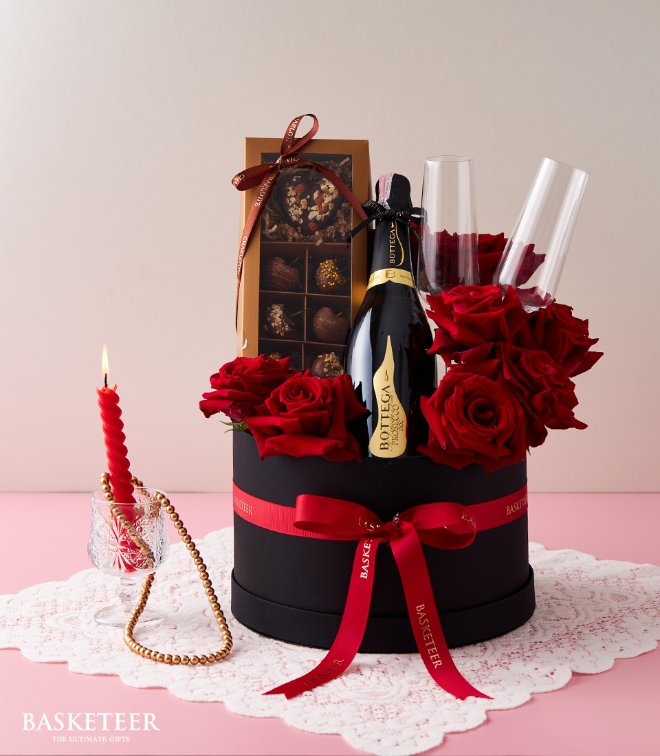 Valentine's day Bottega Prosecco Doc Brut Wine, Red Explorer Roses, Chocolate-Covered Cherries and Flute Champagne Glasses In The Black Box With a Red Bow.