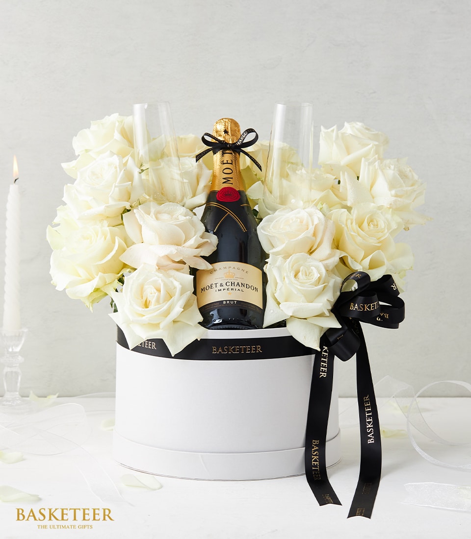 Luxury gift box with Moët & Chandon champagne and elegant white roses beautifully arranged