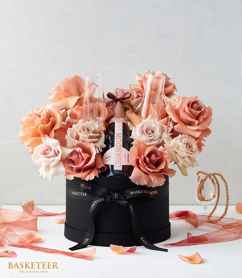 Luxury gift box with Chandon Rosé sparkling wine and peach-pink roses in elegant black round box