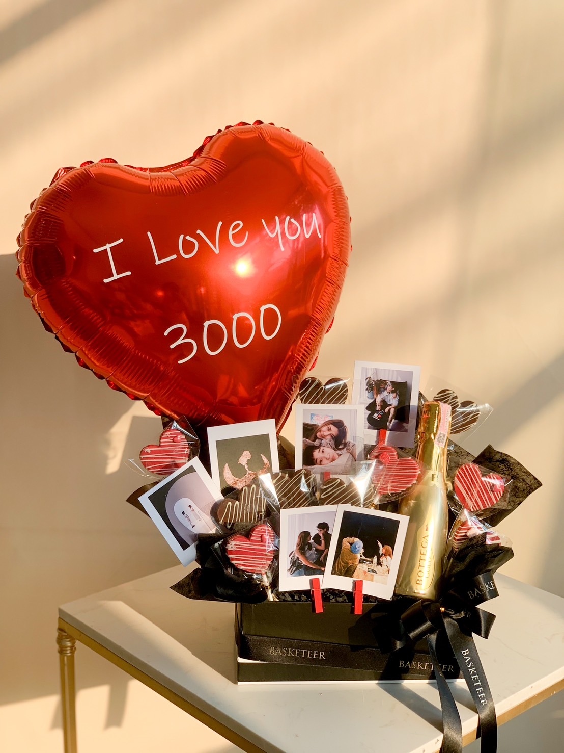 Romantic Valentine’s gift box with a heart balloon, chocolates, a mini prosecco bottle, and personalized photos