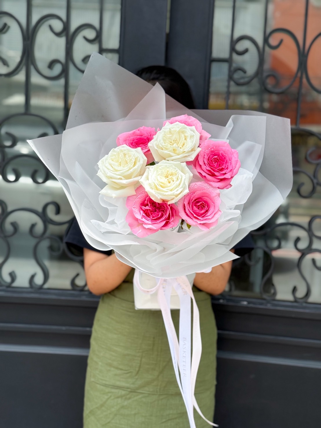 Elegant bouquet of pink and white roses wrapped in soft white paper, perfect for romantic occasions and heartfelt gifts.
