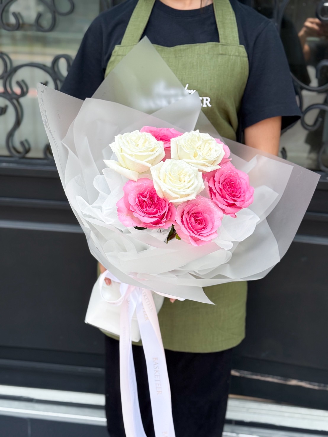 egant bouquet of pink and white roses wrapped in soft white paper, perfect for romantic occasions and heartfelt gifts.