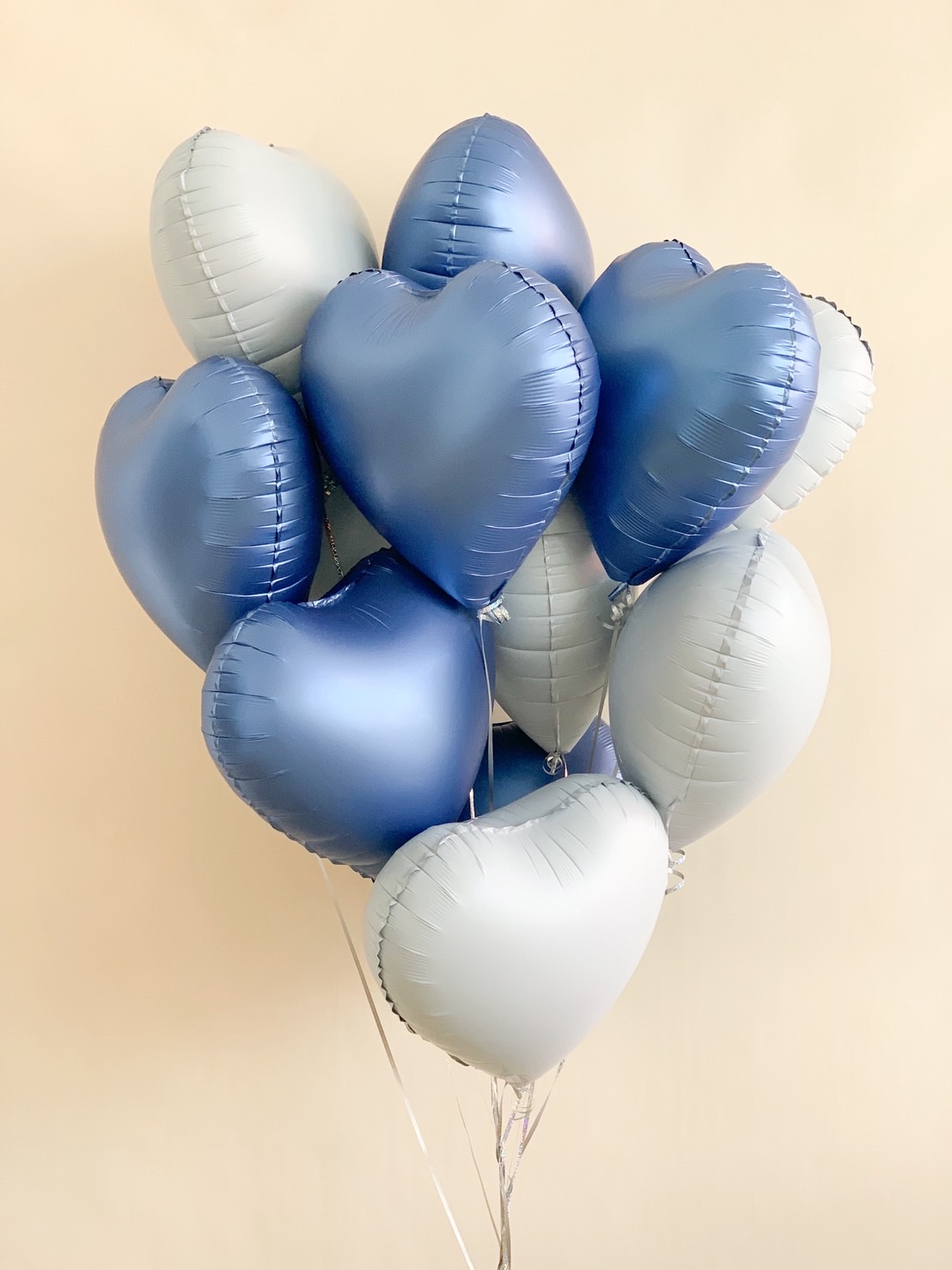 A bouquet of blue and silver heart-shaped foil balloons, perfect for birthdays, anniversaries, or romantic celebrations.