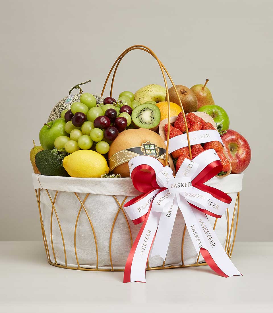 A big gift basket Filled with a variety of high quality fresh fruits such as red apples. Red strawberries, green kiwis, yellow Chinese Pear, and more are decorated with beautiful bows, red and white ribbons, with 