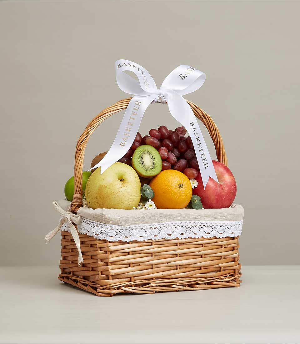 gift baskets Filled with a variety of fresh fruits such as red grapes, yellow pears, green kiwis, and many more. Decorated with a white ribbon bow with the word 